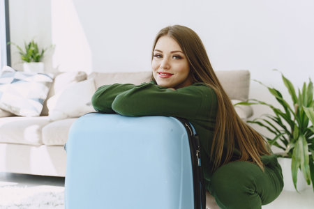 Woman prepare travel suitcase at home