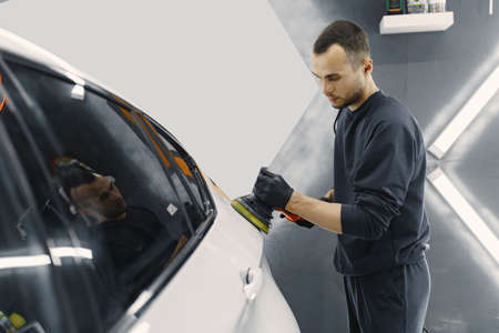 Man polish a car in a garageの写真素材