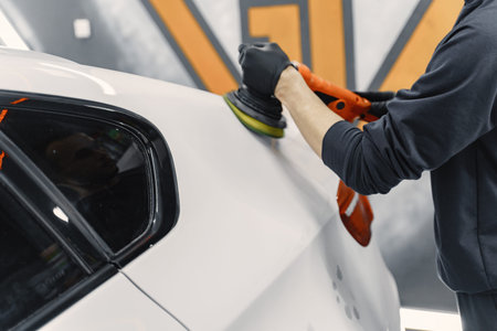 Man polish a car in a garage