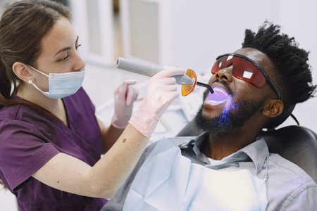 African patient in dentistry sitting in dental chair