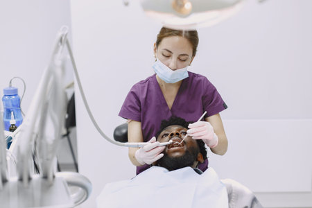 African patient in dentistry sitting in dental chair