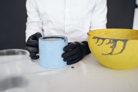 Man in a white shirt works with a cementの写真素材