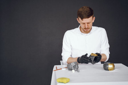 Man in a white shirt works with a cementの写真素材