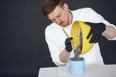 Man in a white shirt works with a cementの写真素材