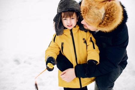 Handsome man on a winter fishing with his little son