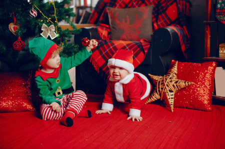 Cutte little brothers at home near christmas decorationsの写真素材