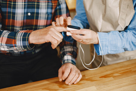 Senior woman and man at home meassure blood pressureの写真素材