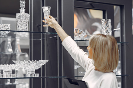 Woman buys dishes in the storeの写真素材