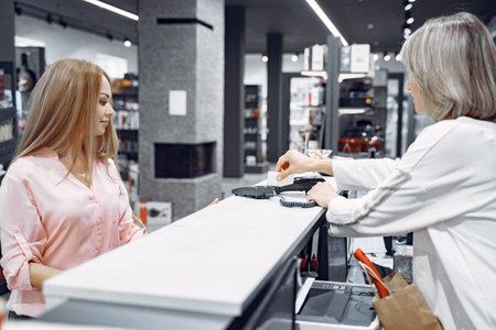 Woman buys dishes in the storeの写真素材