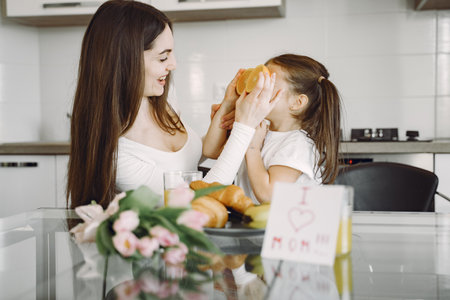 Mother with daughter at homeの写真素材