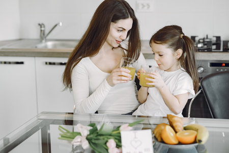Mother with daughter at homeの写真素材