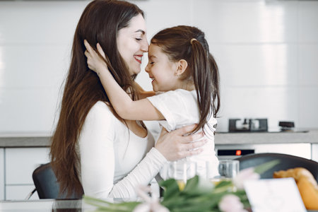 Mother with daughter at homeの写真素材
