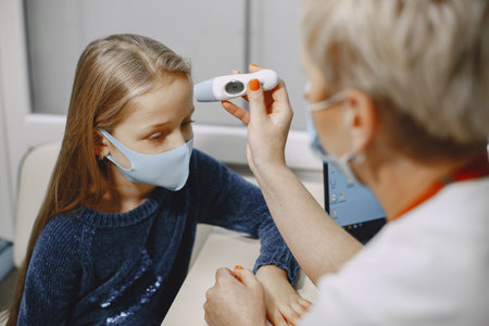 Happy little girl at the doctor for a checkupの写真素材