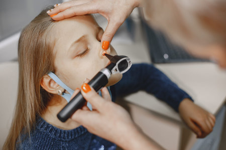 Happy little girl at the doctor for a checkupの写真素材