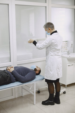 Doctor talking to her male patient at officeの写真素材