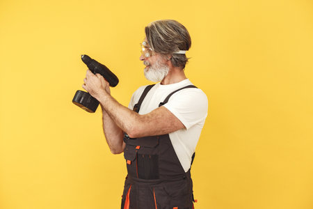 Technician holding instruments on a yellow backgroundの写真素材