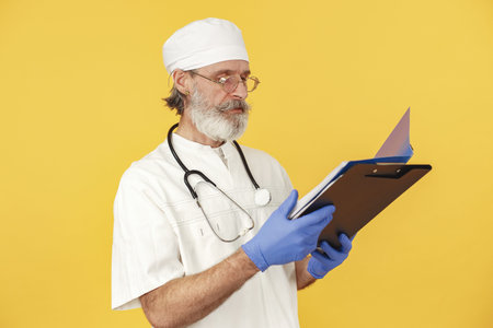 Old doctor standing in a white uniform
