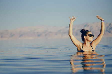brunette girl swimming in the dead sea