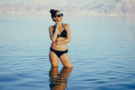 brunette girl swimming in the dead seaの写真素材