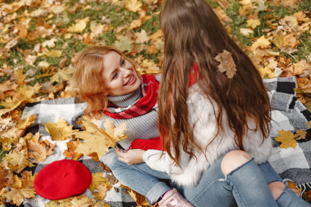 Cute and stylish family in a autumn parkの写真素材