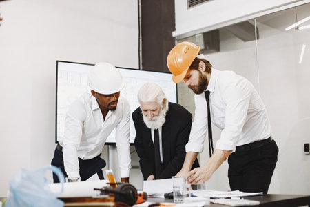 Group of managers in the office with helmetの写真素材