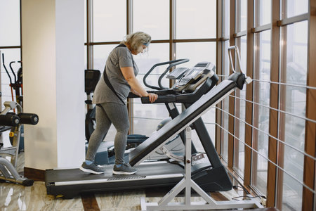 Adult fat woman doing gymnastics at the gym