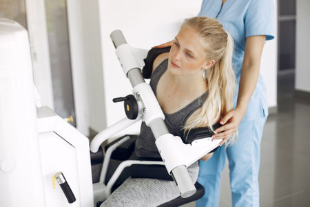 Woman at physiotherapy making physical exercises with qualified therapistの写真素材