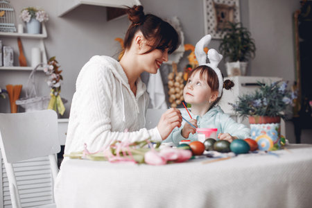 Mother with little daughter in a kitchenの写真素材