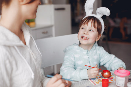 Mother with little daughter in a kitchenの写真素材