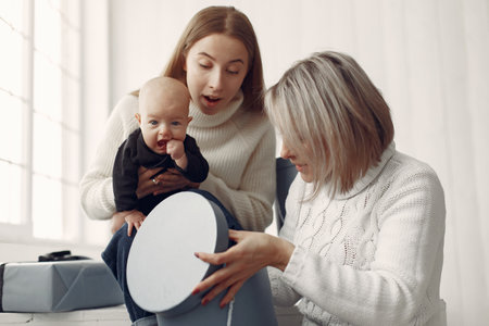 Elegant grandma at home with daughter and granddaughterの写真素材