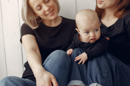 Elegant grandma at home with daughter and grandsonの写真素材