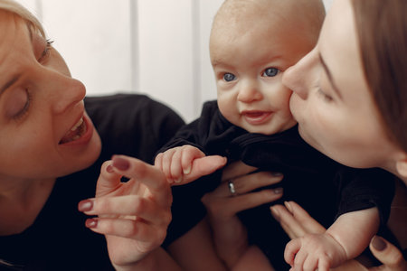 Elegant grandma at home with daughter and grandsonの写真素材