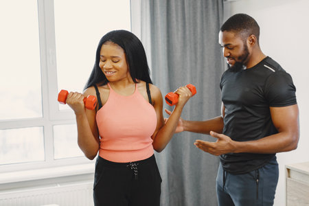 Handsome Afro American couple working out at homeの写真素材