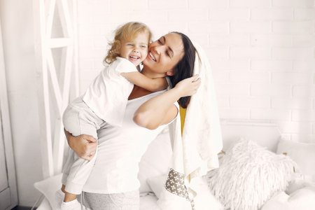 Mother and little daughter have fun at homeの写真素材