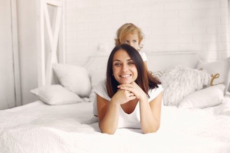 Mother and little daughter have fun at homeの写真素材