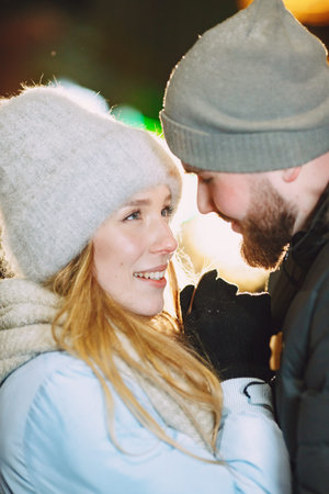 Young couple outdoor in night street at christmas time