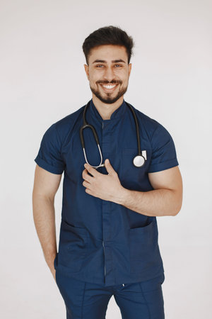 A portrait of a medical doctor posing against white background