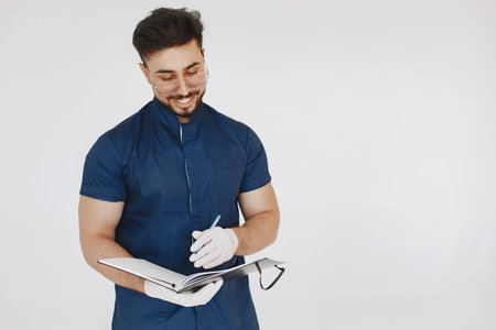 A portrait of a medical doctor posing against white background
