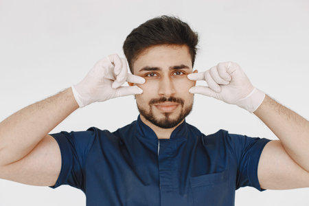 A portrait of a medical doctor posing against white background