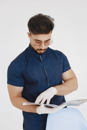 A portrait of a medical doctor posing against white background