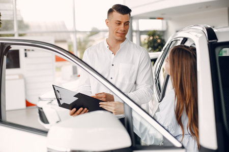 Stylish and elegant woman in a car salonの写真素材
