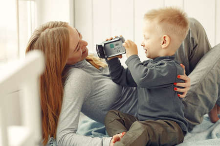 Mother and little son playing at homeの写真素材