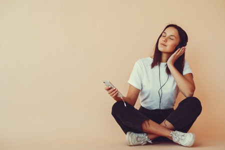 Girl on a yellow background with headphones