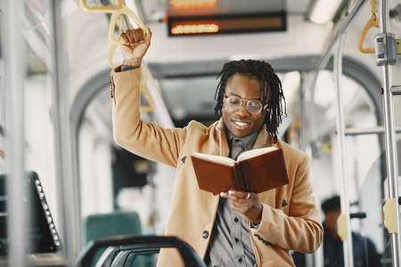 Young African businessman standing on a busの写真素材