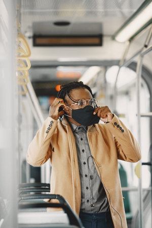 Young African businessman standing in a bus
