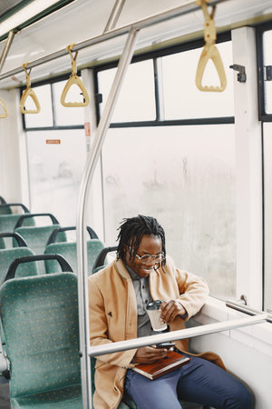 Young African businessman standing on a bus