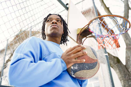 African american man standing with ball on winter dayの写真素材