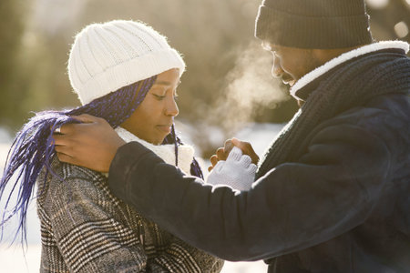 African american couple in a winter forestの写真素材