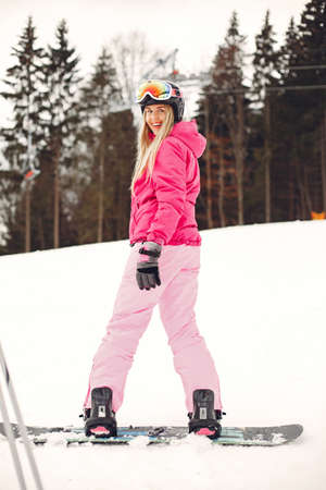 Girl snowboarding in the mountains with the snowboardの写真素材