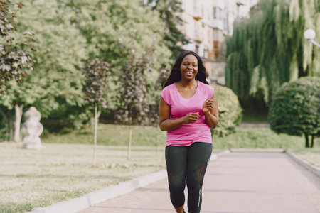 African american woman having workout in park in sportswear